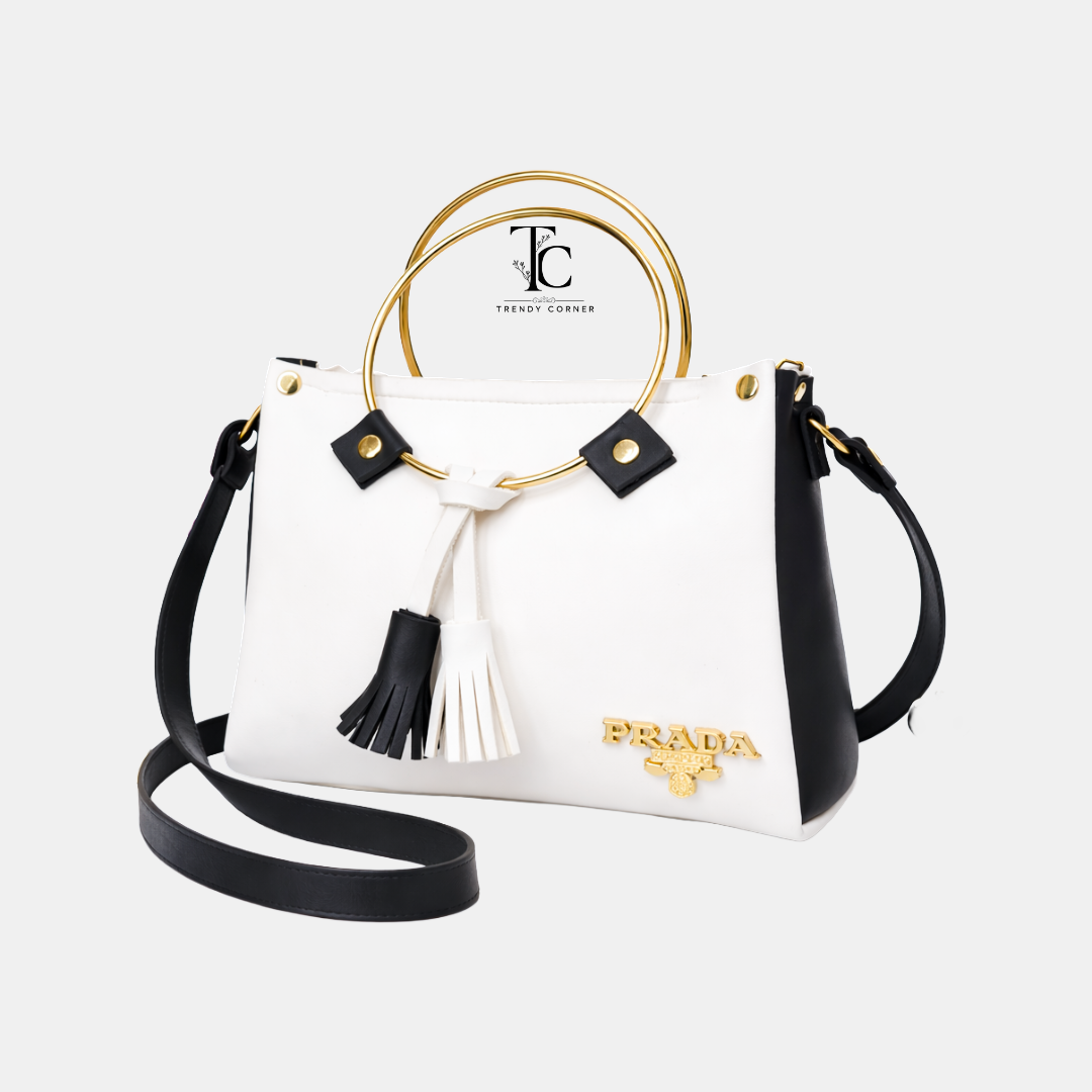 Round white and black women's shoulder bag with sleek design, featuring a comfortable strap and stylish appearance.