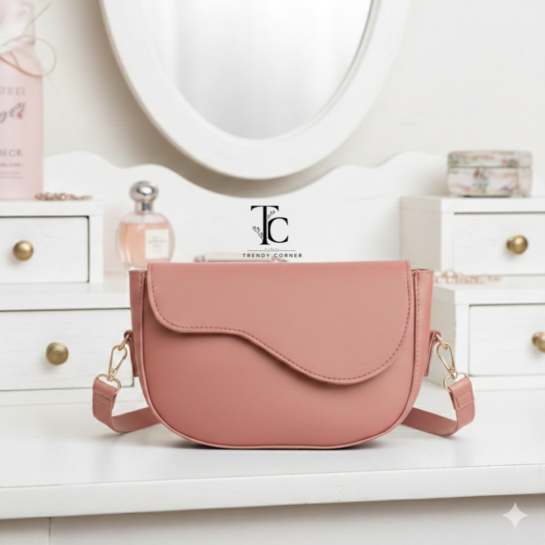 Pink flap curved women's shoulder bag with stylish design, featuring a rounded shape and adjustable strap from Trendyspot.pk