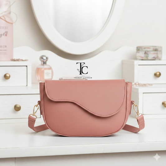 Pink flap curved women's shoulder bag with stylish design, featuring a rounded shape and adjustable strap from Trendyspot.pk