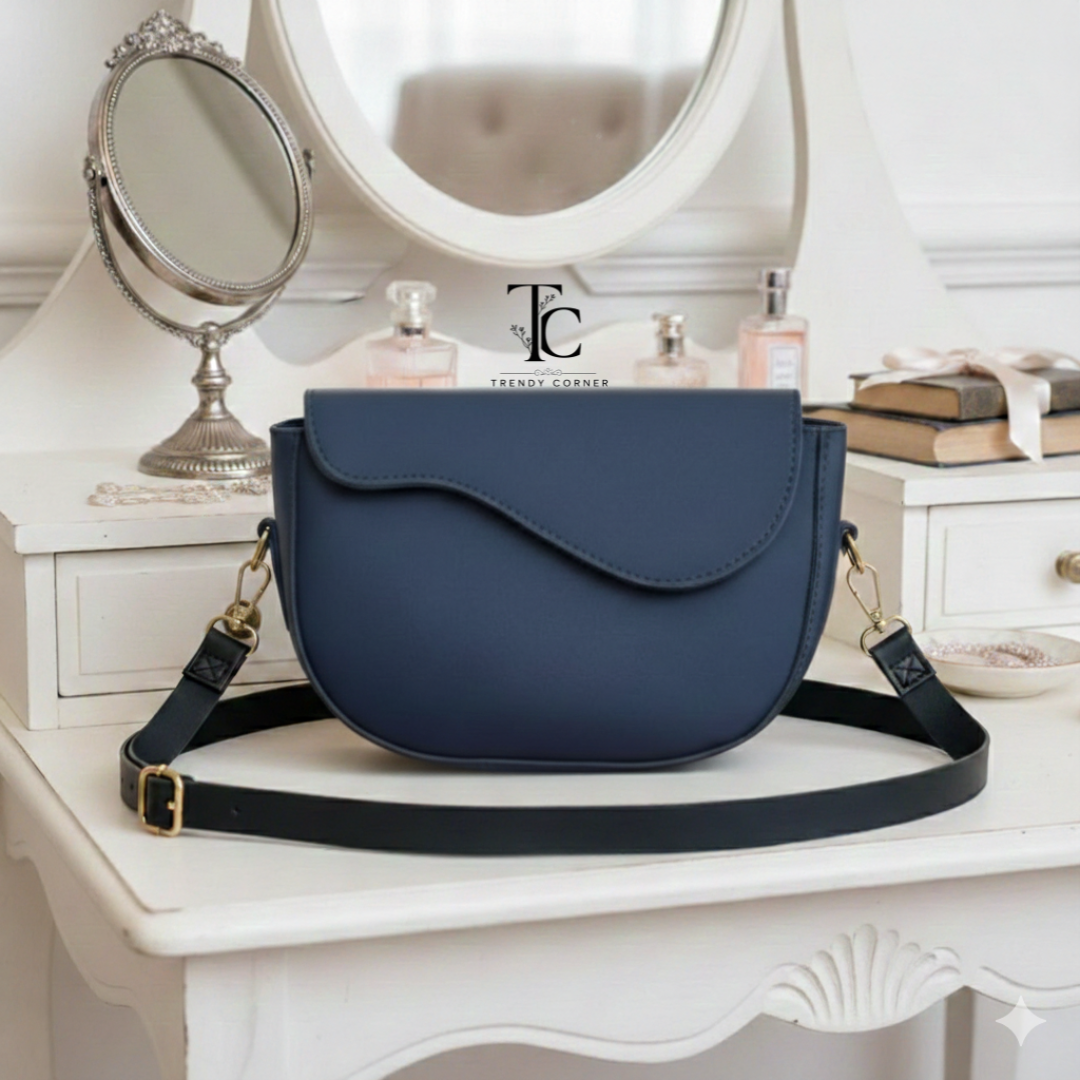 Blue curved flap women's shoulder bag with adjustable strap from Trendyspot.pk, stylish and perfect for casual or formal wear.