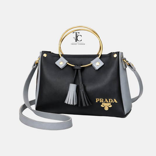 Black and grey women's shoulder bag with round shape and stylish design, perfect for casual or formal occasions.