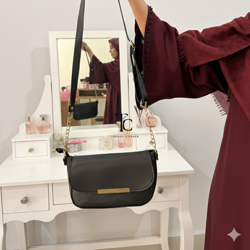 Black women's shoulder bag with flap closure from SHARJEEL.PK, featuring a sleek design and adjustable strap.