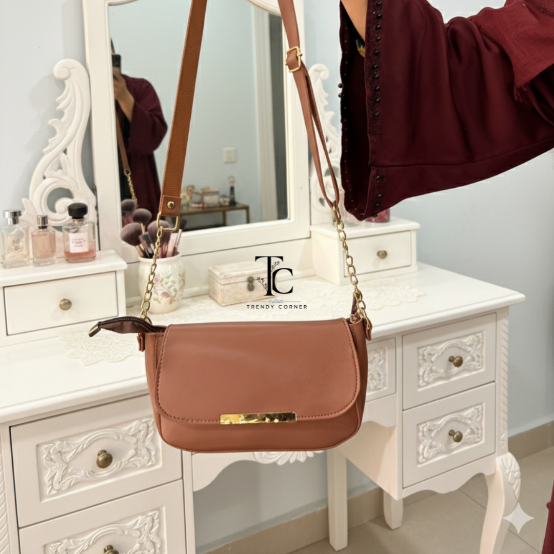 Brown women's shoulder bag with flap closure from Trendycorner.pk, featuring a stylish and functional design.