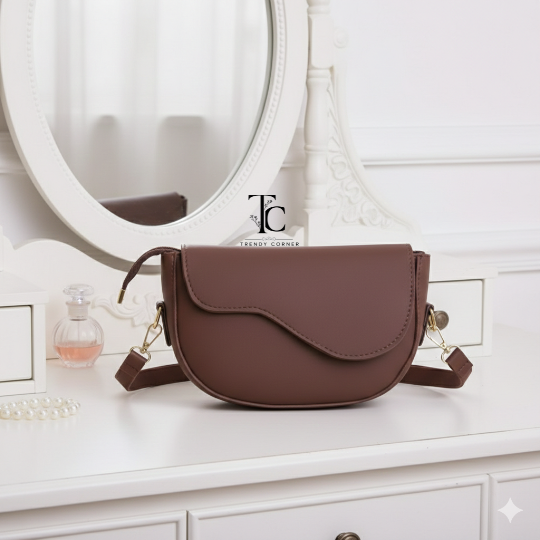 Brown flap curved women's shoulder bag with stylish design, featuring a shoulder strap and trendy details.