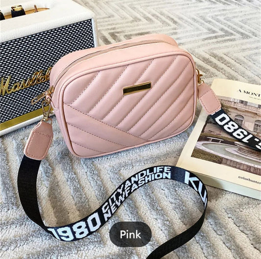 Pink women's crossbody bag from Trendyspot.pk, stylish accessory with adjustable strap and compact design for everyday use.